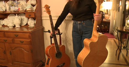 Mrs. Lacharite demonstrates how the empty guitar stand was discovered.