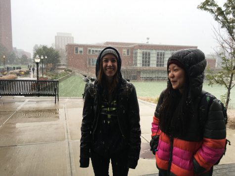 Juniors Alyssa Thompson and Kahani Lee amidst the snowfall on the UMass campus.