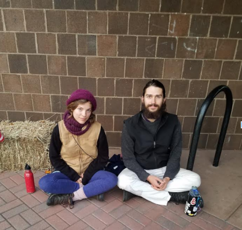 Alice Grendon and Dunan Herman-Parks mediate outside the polls.