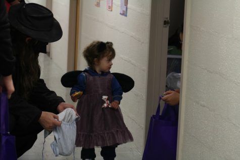 Freshman computer science major Gizen Cicekli awaits trick-or-treaters in Mary Lyon Hall as she celebrates her first Halloween in the U.S.