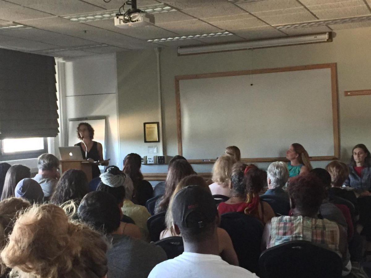 Panelist Kim Gilhuly addresses a room full of public health students and faculty in the Campus Center.
