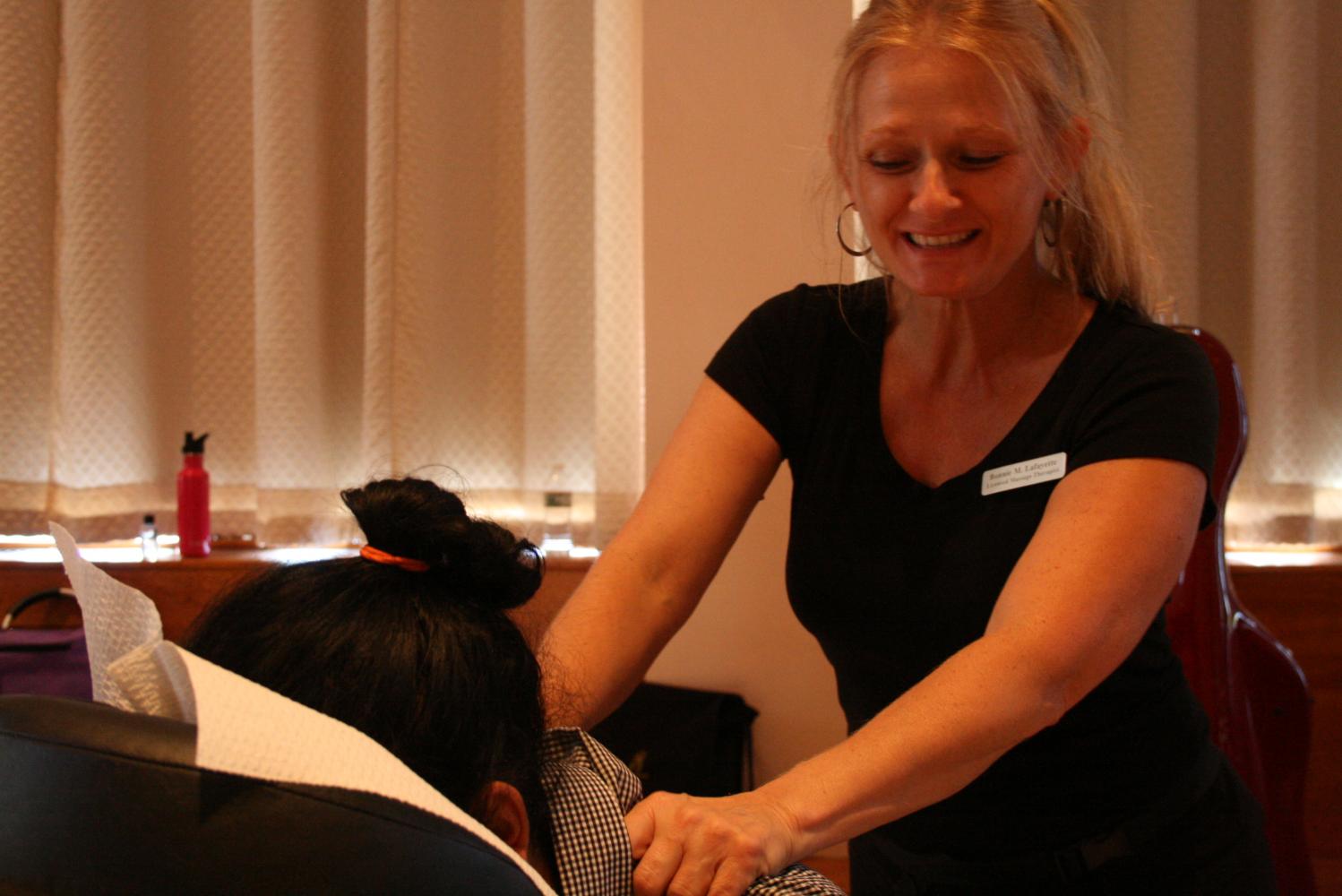 Massage therapist Bonnie M. Lafayette massaging UMass grad student Costin Thampikutty (Brian Choquet/Amherst Wire)