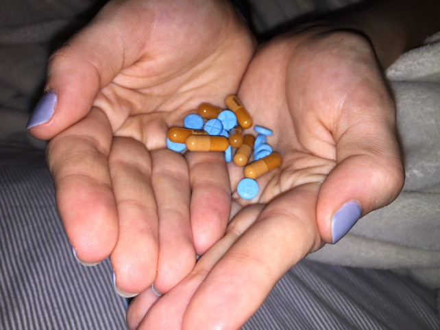 Bailey holds an assortment of Adderall IR and Adderall XR that she brought to school with her.