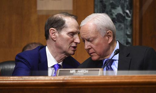 Sen. Ron Wyden, D-Ore., left, talks with committee chairman Sen. Orrin Hatch, R-Utah, right, while Treasury Secretary Steven Mnuchin testifies before the Senate Finance Committee on Capitol Hill in Washington on Feb. 14 at President Trumps fiscal year 2019 budget proposal. (Susan Walsh/AP Photo)