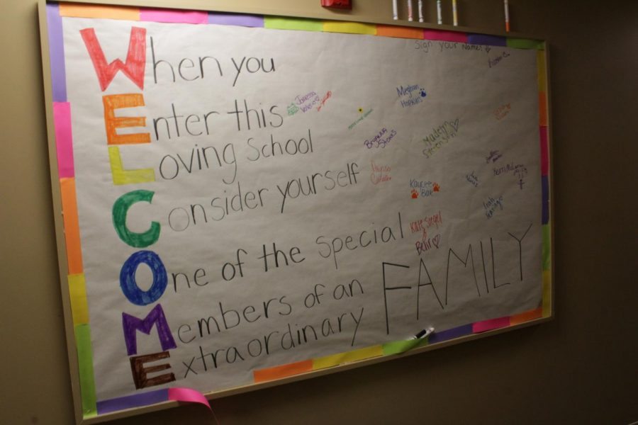 A bulletin board reads WELCOME on the first floor of New Hall (Brian Choquet/ Amherst Wire).
