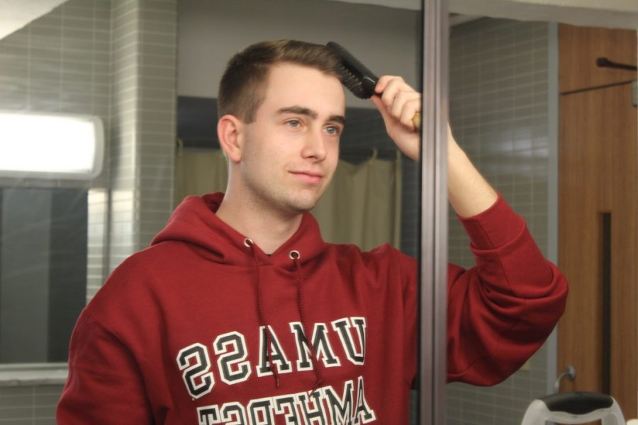UMass Freshman Patrick Lavey takes a moment to brush his hair. (David Anderson/Amherst Wire)