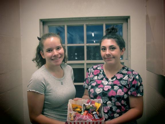 Freshman Tori Ross (left) and Kenzie Velardo (right)
handing out Halloween candy at the Northeast Residential Area.  
