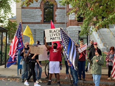 Black Lives Matter supporter in the middle of Trump supporters by Tristan Smith