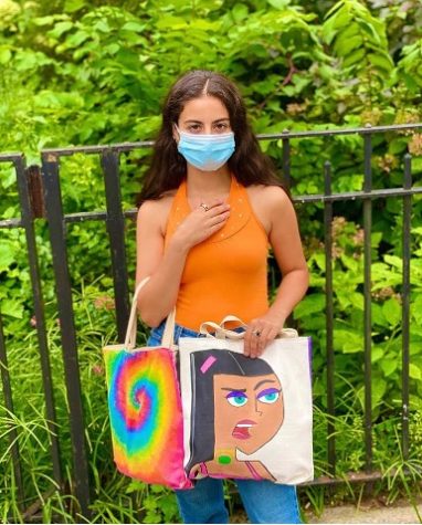 Pictured: Samet with 2 of her hand painted bags. Photo from @cutelilbaggies on Instagram