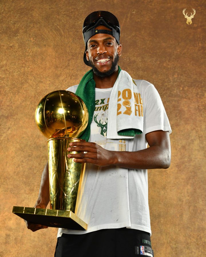 Khris Middleton holds the Larry O'Brien trophy. (Credit to the Bucks Twitter)