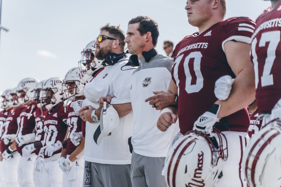 Former Coach Walt Bell with members of the UMass Football team courtesy of Massachusetts Athletics on Flickr