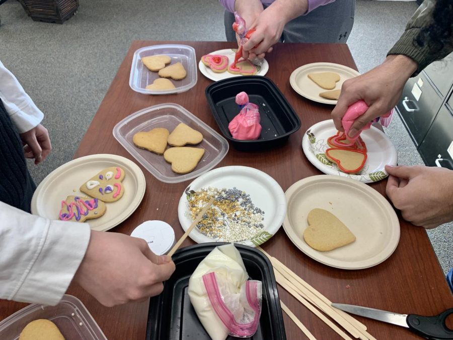 UMass students decorate Valentine's Day cookies at the W.E.B. Du Bois Library during a food writing journalism class.