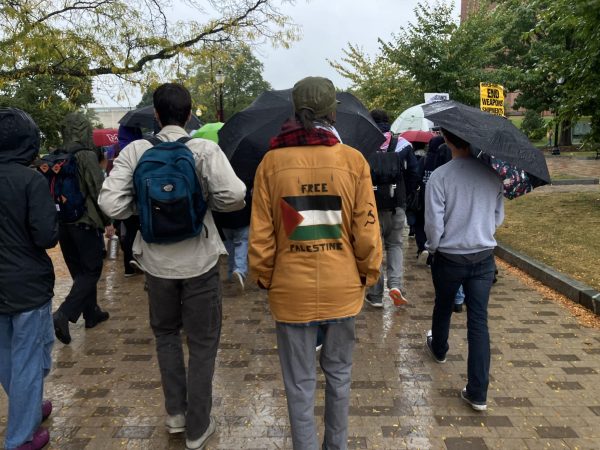 Rain didn’t deter around 70 rallygoers who marched from the Student Union to the Whitmore Administration Building.