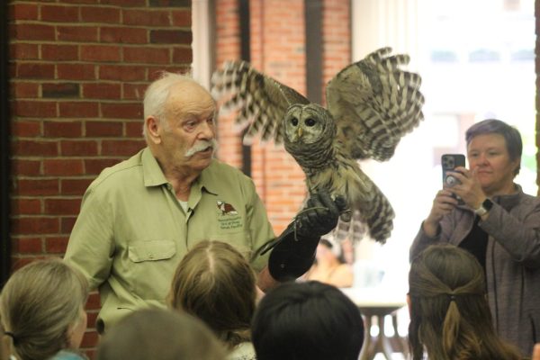 Tom Ricardi displays one of his raptors, a barred owl. 