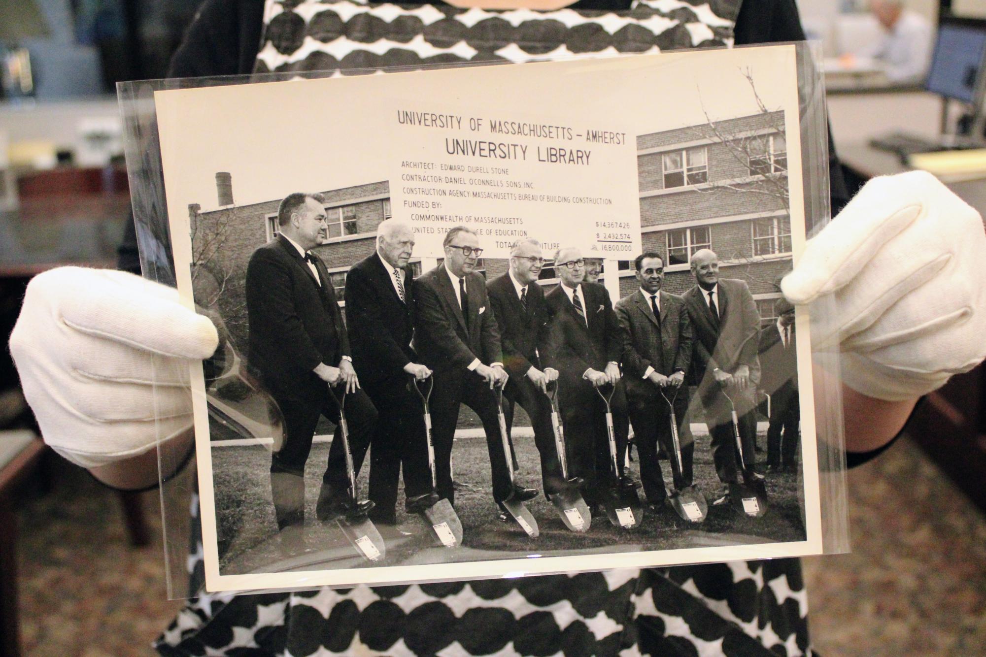 Libby Coyner holds up a photograph from the 1969 groundbreaking for the construction of the W.E.B. Du Bois Library on Nov. 20, 2025.