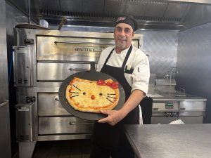 Joe Denoronha presents his famous Hello Kitty pizza in Hampshire Dining Commons.