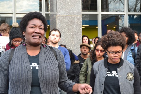 UMass doctoral candidate Markeysha Davis (left) is overcome with emotion while speaking.